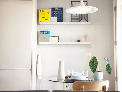 a dining room with a table and a lamp at D858 - comfort near downtown - AC & balcony in Porto