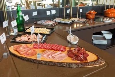a tray of meats and other food on a counter at NEYA Porto Hotel in Porto