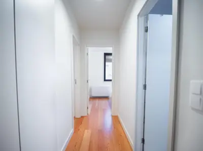 a hallway with white walls and a wooden floor at Oporto City View - Alves da Veiga in Porto