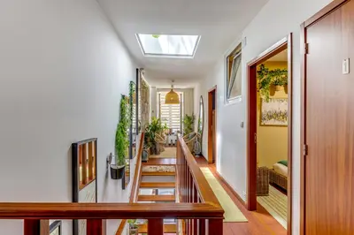 a hallway with stairs and a skylight at Garden in Town Hostel in Porto