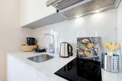 a bathroom with a sink and a shower and a bed at Porto Downtown Studio w/ Balcony in Porto