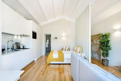 a living room with a couch and a bed at Porto Downtown Studio w/ Balcony in Porto