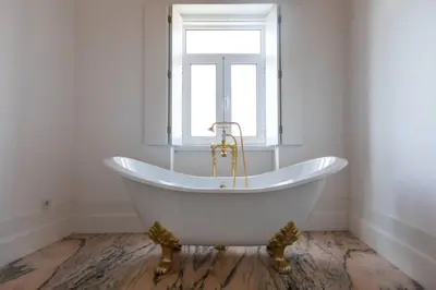 a white bath tub in a bathroom with a window at Oporto Down Town in Porto