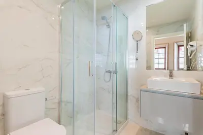 a bathroom with a shower and a toilet and a sink at Lemago Porto Apartments - São Bento in Porto