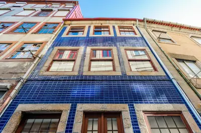 a tall building with blue tile on it at Lemago Porto Apartments - São Bento in Porto