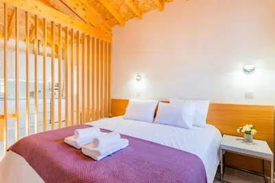 a bedroom with a bed with towels on it at Lemago Porto Apartments - São Bento in Porto