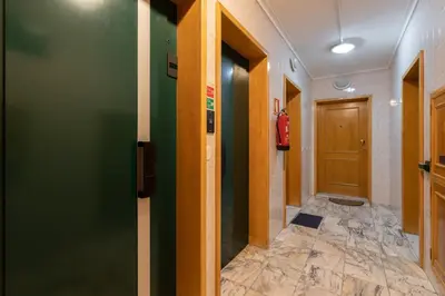 a hallway with green walls and a door at GuestReady - Modern 2BR Flat in Vila Nova de Gaia in Porto