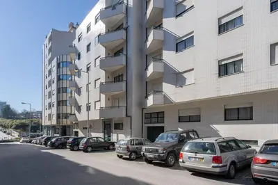 a row of cars parked in front of a building at GuestReady - Modern 2BR Flat in Vila Nova de Gaia in Porto