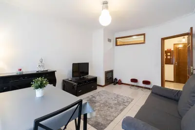 a living room with a table and a couch at GuestReady - Modern 2BR Flat in Vila Nova de Gaia in Porto