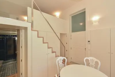 a white dining room with a white table and chairs at Duque - Guest House in Porto