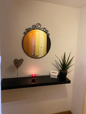 a mirror on a wall above a shelf with a candle at Peter Flat - Rio Douro & Caves Vinho do Porto in Vila Nova de Gaia