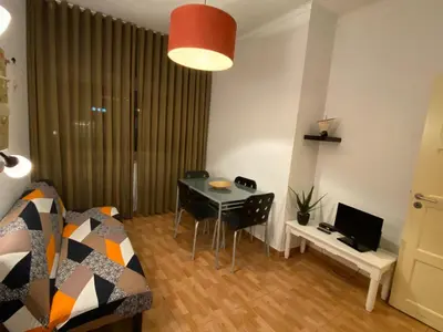 a small living room with a table and a couch at Peter Flat - Rio Douro & Caves Vinho do Porto in Vila Nova de Gaia