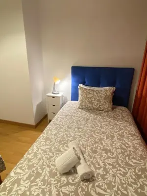 a bedroom with a bed with a blue headboard at Peter Flat - Rio Douro & Caves Vinho do Porto in Vila Nova de Gaia