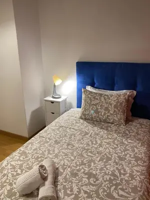 a bedroom with a bed with a blue headboard at Peter Flat - Rio Douro & Caves Vinho do Porto in Vila Nova de Gaia