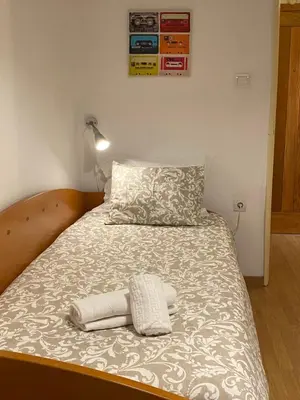a bed with two towels on top of it at Peter Flat - Rio Douro & Caves Vinho do Porto in Vila Nova de Gaia