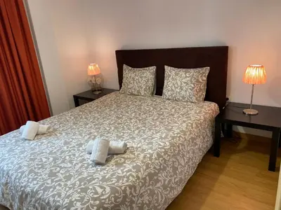 a bedroom with a large bed with two night stands at Peter Flat - Rio Douro & Caves Vinho do Porto in Vila Nova de Gaia