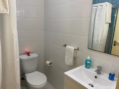 a bathroom with a toilet and a sink and a candle at Peter Flat - Rio Douro & Caves Vinho do Porto in Vila Nova de Gaia