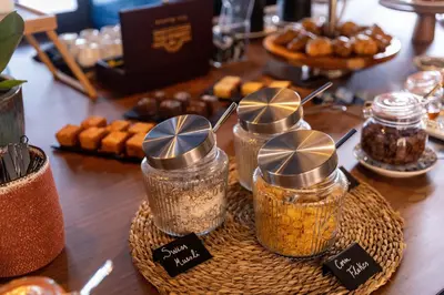 a table with jars of food on a table with pastries at chic&basic Gravity in Porto