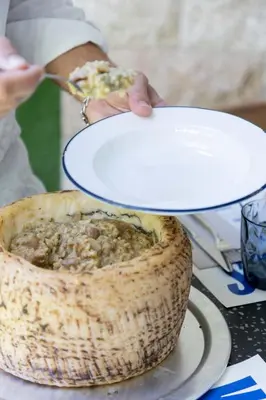 a person holding a plate over a bowl of food at chic&basic Gravity in Porto