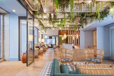 a restaurant with tables and chairs and a bar at Pur Oporto Boutique Hotel by actahotels in Porto