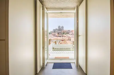 a hallway with a view of a city from a window at Vitória over the roof I in Porto