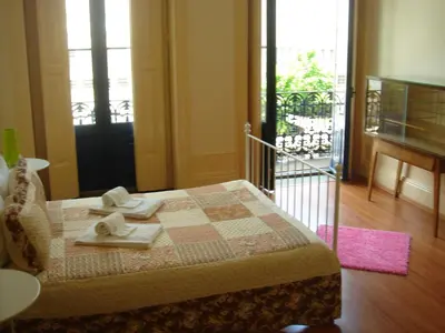 a bedroom with a bed with two towels on it at CoolHostel in Porto