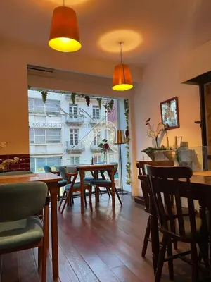 a dining room with tables and chairs and a window at Linha 22 in Porto