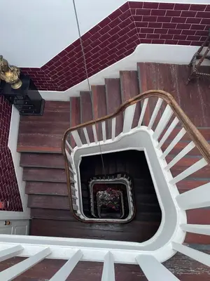 a spiral staircase in a building with a fireplace at Linha 22 in Porto