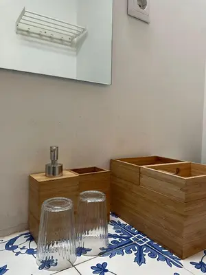 a bathroom with two glass stools and a mirror at Linha 22 in Porto