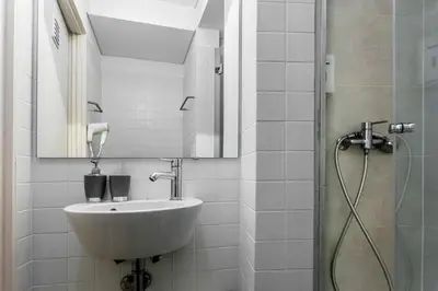 a bathroom with a sink and a shower at Citybreak-apartments Lapa in Porto
