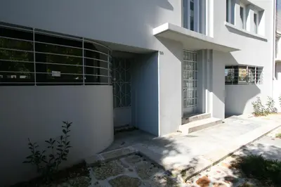 a white building with a door and a window at OPO.APT - Art Deco Apartments in Oporto's Center in Porto