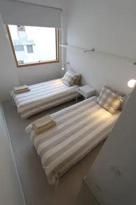 two beds in a room with a window at OPO.APT - Art Deco Apartments in Oporto's Center in Porto