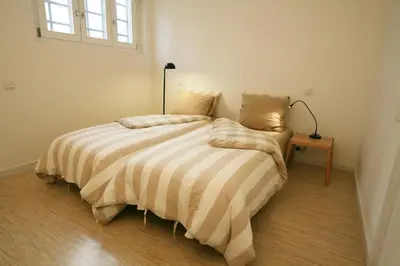 a bedroom with a bed with a lamp on it at OPO.APT - Art Deco Apartments in Oporto's Center in Porto