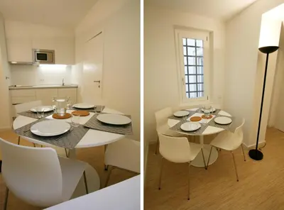 a kitchen and a dining room with a table and chairs at OPO.APT - Art Deco Apartments in Oporto's Center in Porto