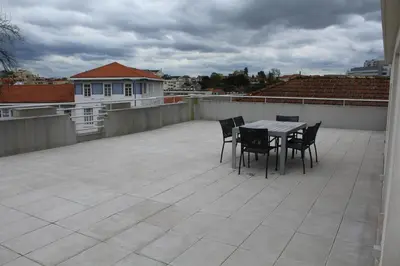 a patio with a table and chairs on a roof at OPO.APT - Art Deco Apartments in Oporto's Center in Porto