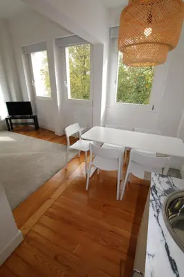 a white dining room with a table and chairs at OPO.APT - Art Deco Apartments in Oporto's Center in Porto