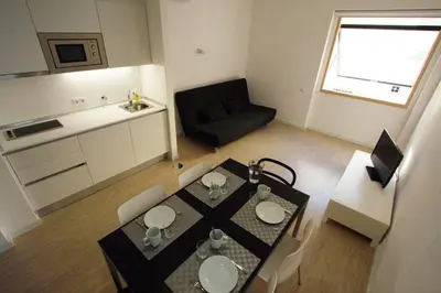 a small apartment with a dining table and a kitchen at OPO.APT - Art Deco Apartments in Oporto's Center in Porto