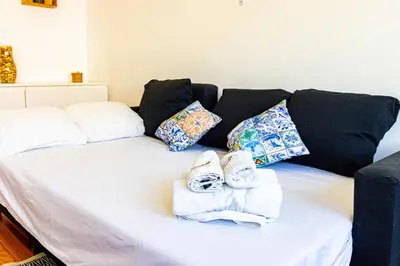 a white bed with towels and pillows on it at Guest H4U - Porto Batalha City Center in Porto