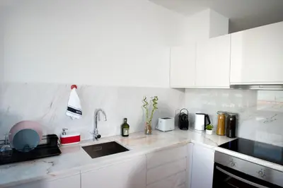 a kitchen with white cabinets and a sink at Guest H4U - Porto Batalha City Center in Porto