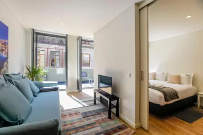 a living room with a bed and a couch at Oliveira Apartment`s in Porto