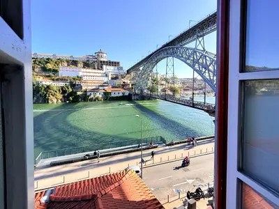 a view of a bridge and a river from a window at Ribeira Cinema Apartments in Porto