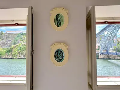a room with a window and two statues on the wall at Ribeira Cinema Apartments in Porto