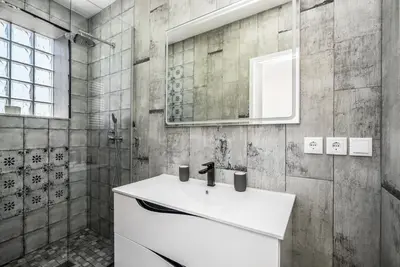 a bathroom with a white sink and a shower at Maredimo Village Porto Casa 2 in Porto