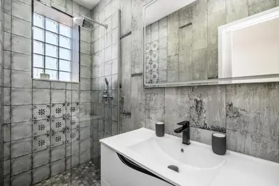 a bathroom with a white sink and a shower at Maredimo Village Porto Casa 2 in Porto