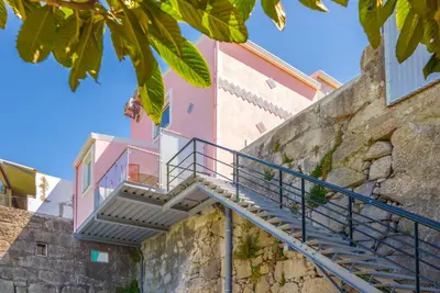 a staircase leading up to a pink building at Maredimo Village Porto Casa 2 in Porto