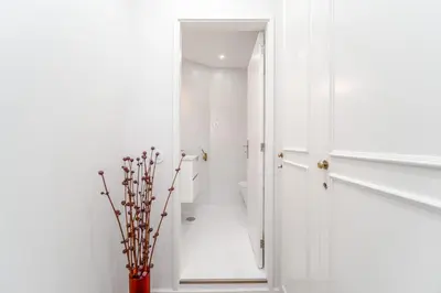 a bathroom with white walls and a mirror at Nomad's By Sta Catarina Flats - 3BED Porto in Porto