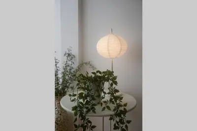 a white table with a pendant light and plants at Softly Porto in Porto