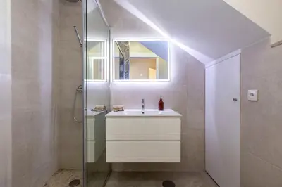 a bathroom with a sink and a glass shower at Classy Belas Artes in Porto
