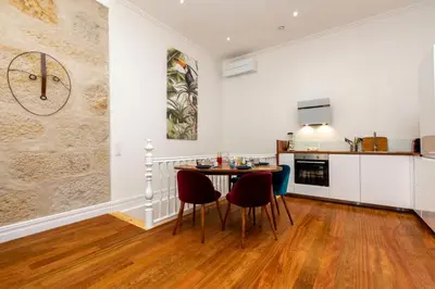 a kitchen with a table and chairs in a room at Classy Belas Artes in Porto