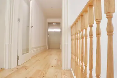 a hallway with wood floors and a stair case at Porto Domus 210 Duplex in Porto